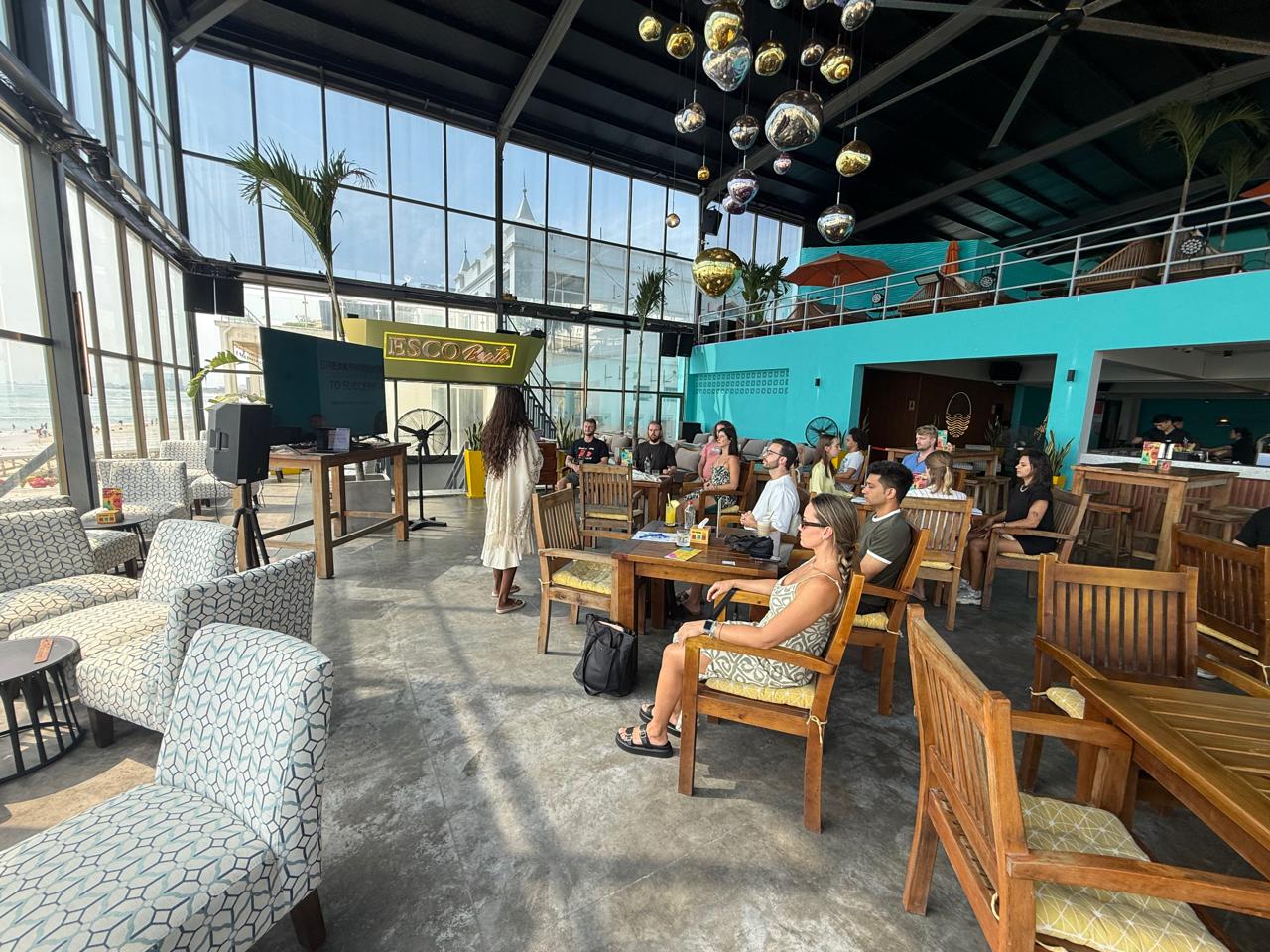 ESCO Beach signboard — the venue, intimate session in progress.